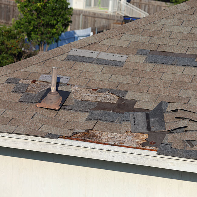 close up of a shingle roof with loose shingles and pipe boot on top lansing mi