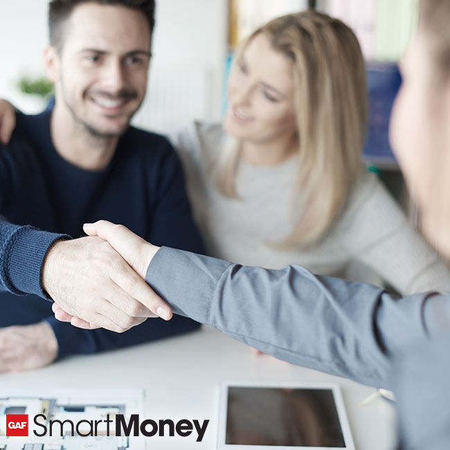 man shaking hands with roofing contractor after reviewing financing options for his roofing project lansing mi