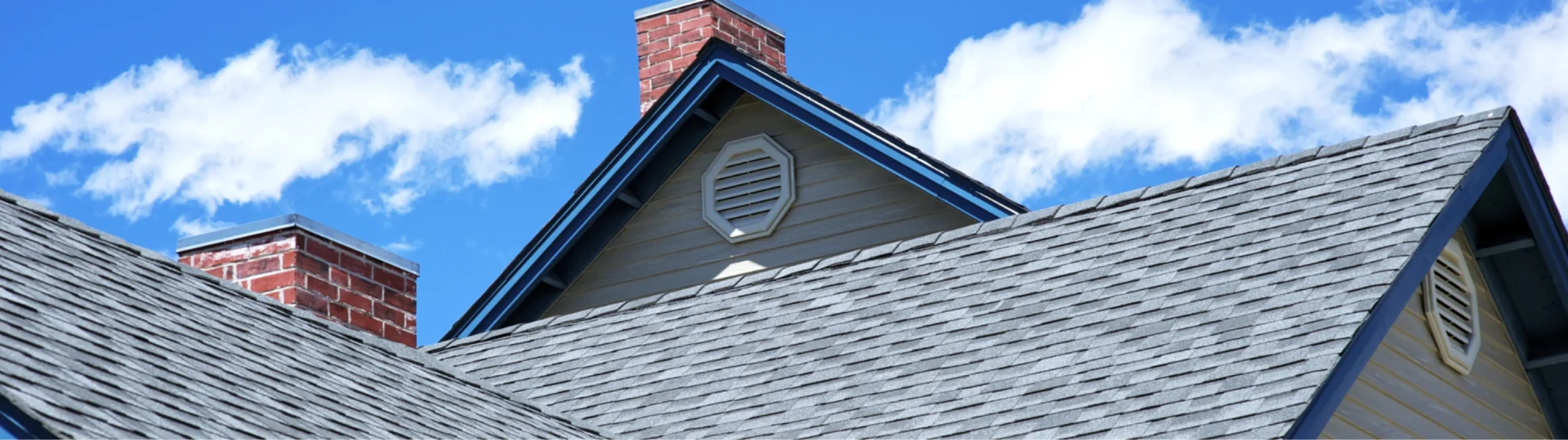 blue sky and light gray shingle roof